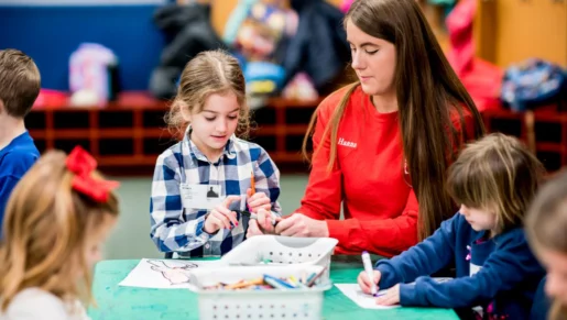 Wheaton Sport Center child care staff drawing with children