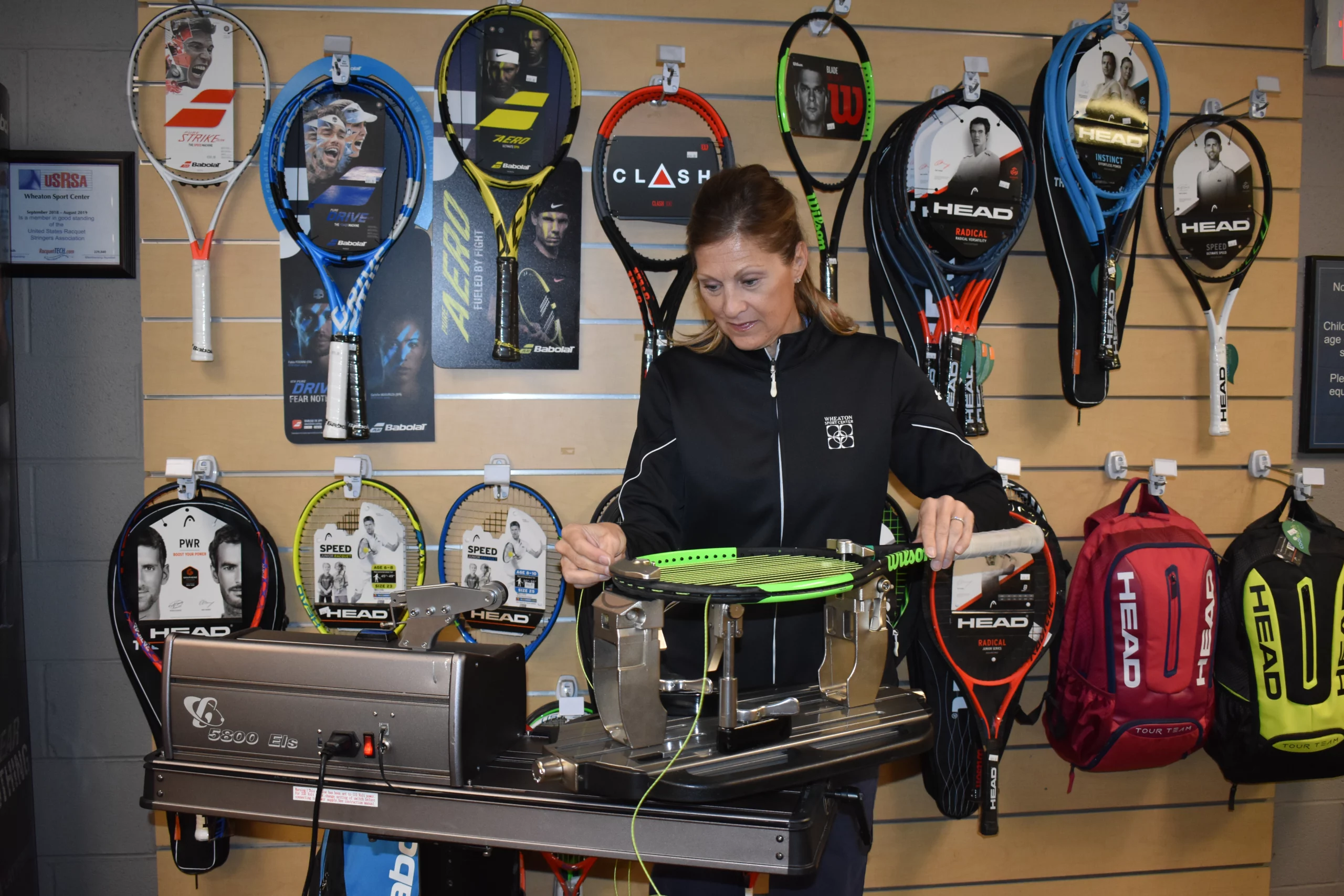 Wheaton Sport Center tennis racket being restrung