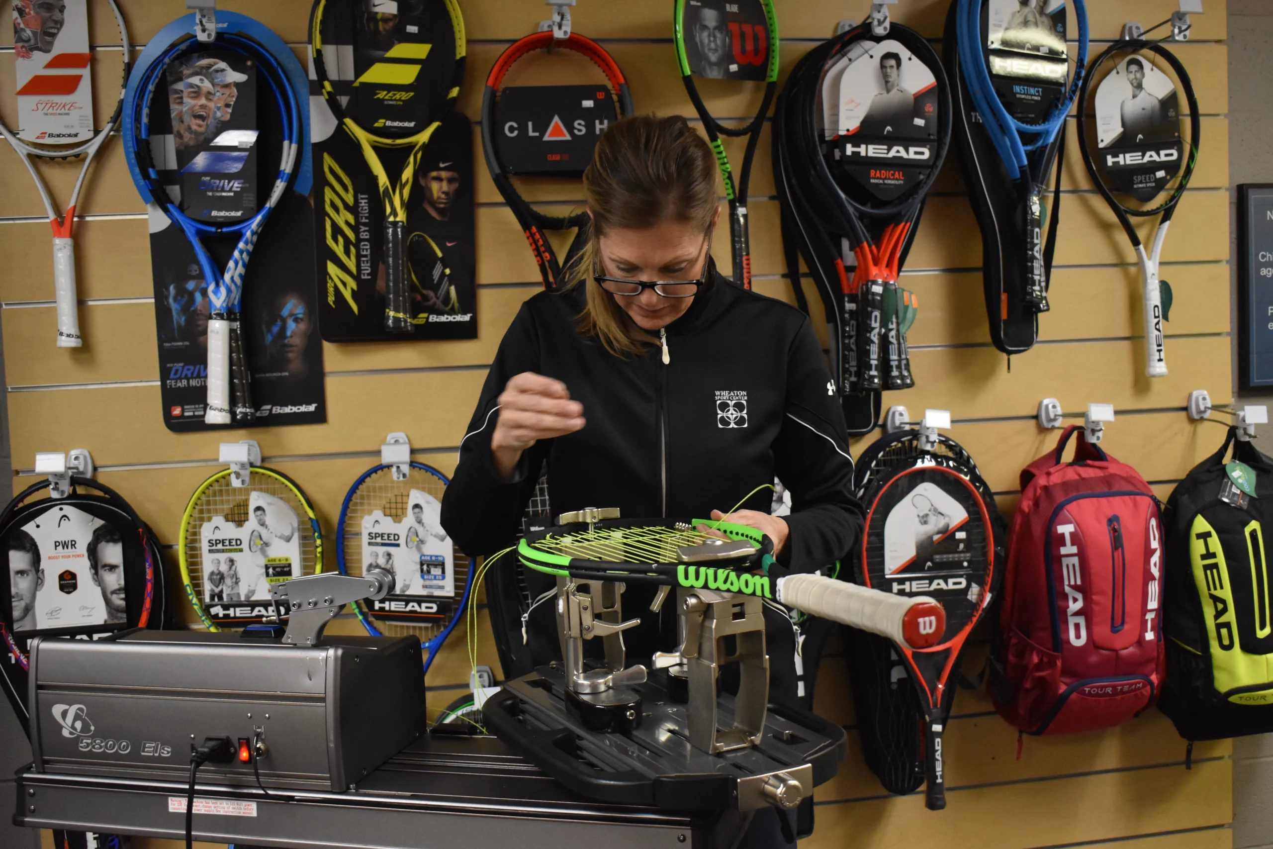 Wheaton Sport Center tennis racket being restrung