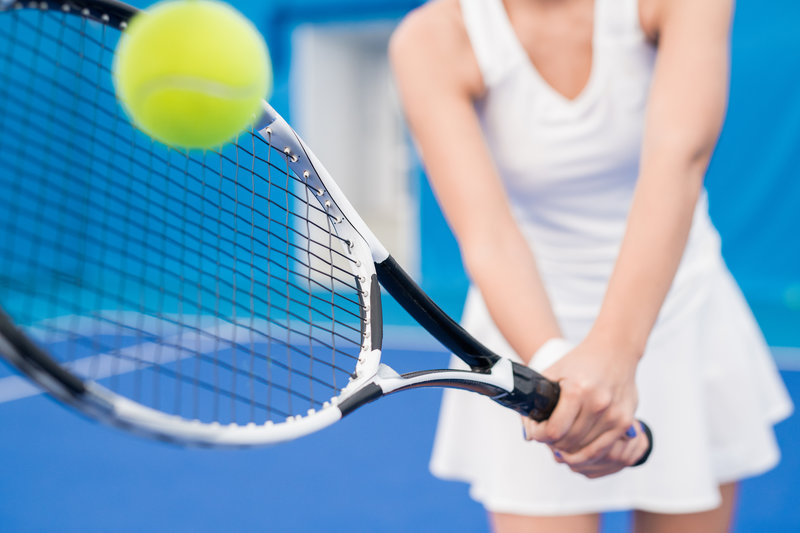 Wheaton Sport Center woman hitting tennis ball