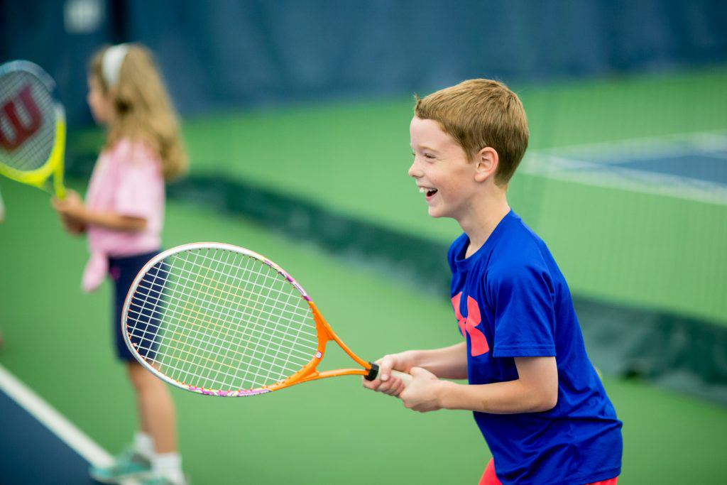 Wheaton Sport Center child smiling during tennis lesson