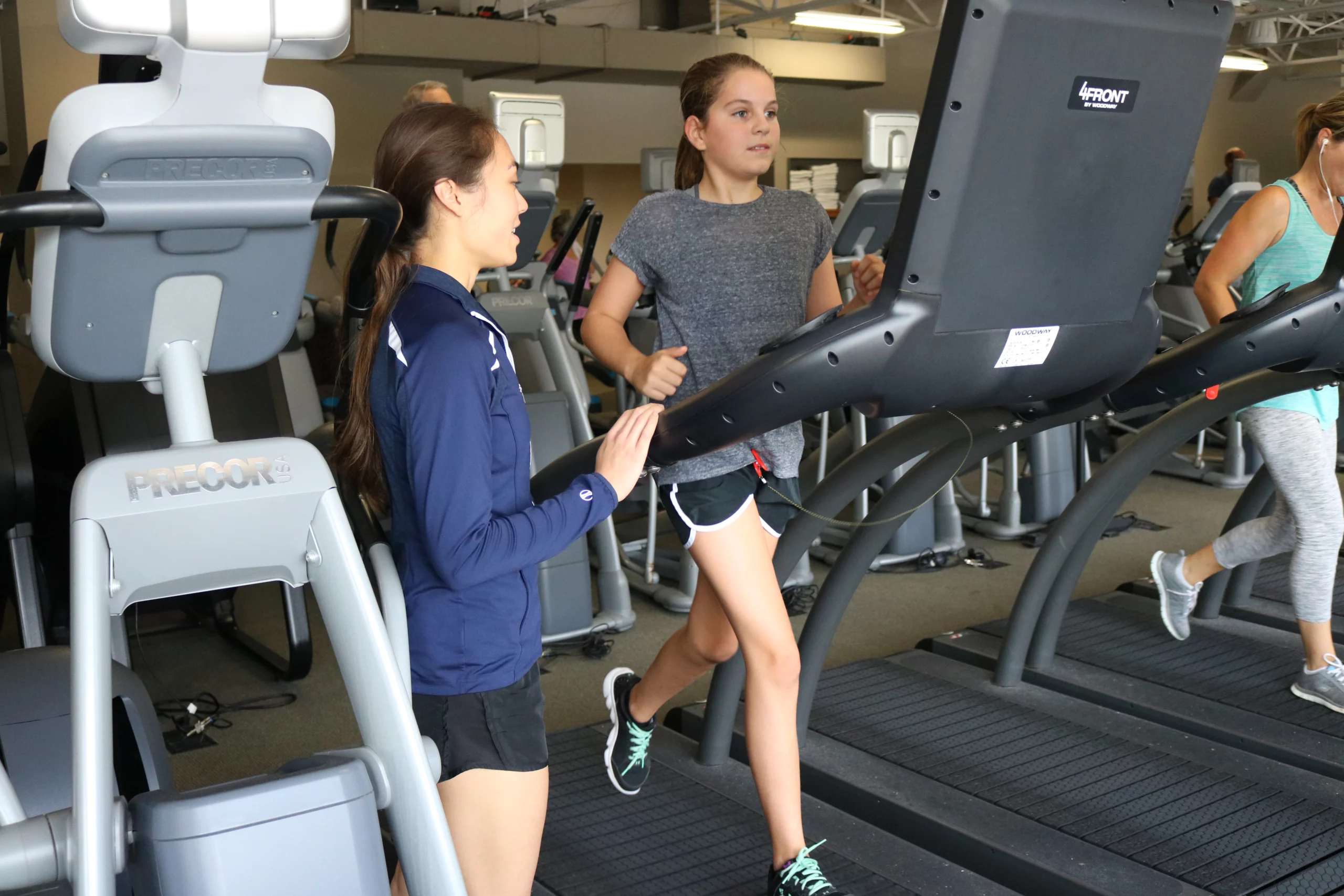 Wheaton Sport Center works out with trainer, running on treadmill