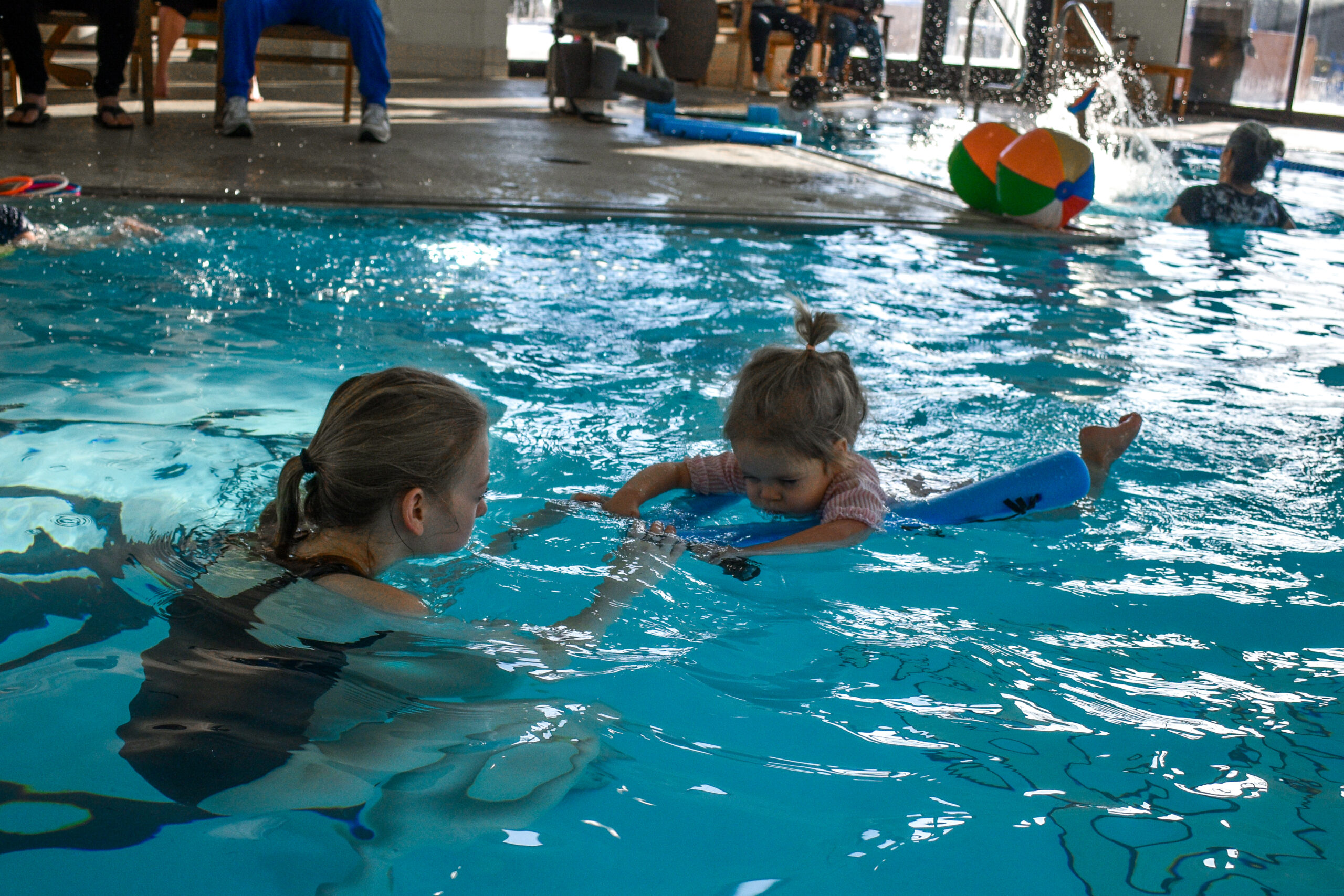 Wheaton Sport Center child swimming in swimming lessons with swim instructor