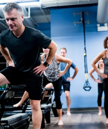 Wheaton Sport Center Men and women working out in Pilates Reformer class